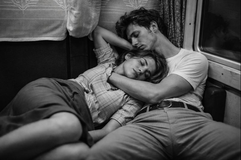 Couple sharing a quiet moment of connection on a train journey